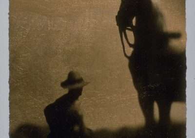 Silhouette of a cowboy tipping his hat to a horse against a textured golden background, suggesting a scene in the evening light. artistic, monochrome portrayal.