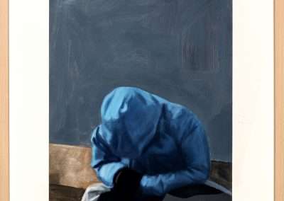 Painting of a person in a blue hoodie, seated with their head down on a surface, set against a dark grey background, enclosed in a wooden frame.