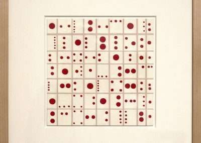 Art piece featuring a grid of squares, each containing red dots in various configurations, framed in a simple wooden frame. the background is light beige.
