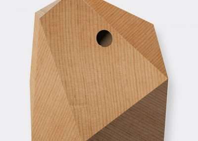 A minimalist wooden birdhouse shaped like a pentagon with a single round entrance hole, isolated on a white background.