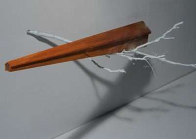 A wooden pencil appears suspended in mid-air, seemingly breaking through a white surface with dynamic shards and shadows on a gray background.