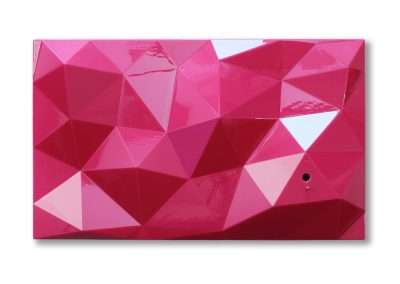 Pink, multi-faceted geometric panel with a glossy finish, reflecting light off its angular surfaces. there is a small hole near one edge.