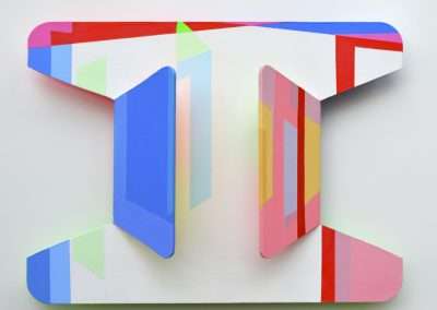 Modern abstract artwork on a wall featuring geometric shapes in vibrant colors such as blue, red, green, and yellow, creating a three-dimensional illusion.