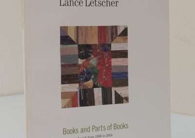 A book titled 'Lance Letscher: Books and Parts of Books,' showing a cover with a collage of colorful, patterned paper strips and a star design in the middle.