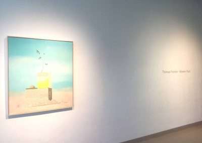 A modern art painting titled "Modern Rain" by Thomas Frontini hanging on a gallery wall, depicting a surreal scene with birds, a ladder, and a sun shower on a sandy landscape.