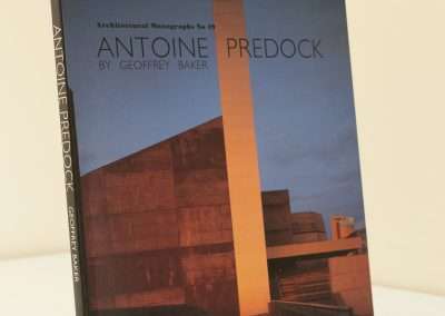 A book titled "Antoine Predock" by Geoffrey Baker, from the Architectural Monographs series, featuring a photograph of a modern building at sunset on the cover.