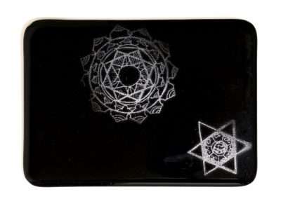 A black rectangular object displaying white geometric patterns resembling intricate mandala designs, making it one of my favorite things and a thoughtful gift idea.