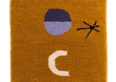 A square, orange rug with an abstract design featuring a purple circle, a white crescent moon, and a black stick figure-like drawing resembling an ant, incorporating elements of my favorite things.
