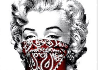 Black and white image of a woman's face, reminiscent of a vintage Hollywood style, with her lower face covered by a red bandana featuring a paisley pattern.