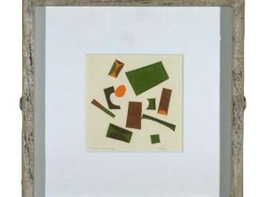 A framed abstract art piece, reminiscent of Frederick Hammersley's style, featuring various geometric shapes in green, brown, and orange. The shapes are randomly scattered on a white background, and the frame has a rustic, weathered wooden look.