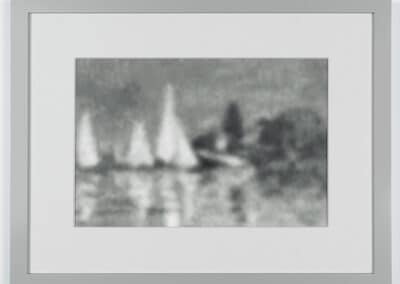 A framed, blurred grayscale image featuring several sailboats on a body of water. The boats are indistinct and appear to be clustered together, with a hazy background that suggests either fog or a distant shoreline with trees.